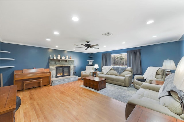 91 Meyerhoff Rd, Hurleyville, NY 12747 - living area featuring crown molding, light wood-style floors, ceiling fan, a fireplace, and visible vents