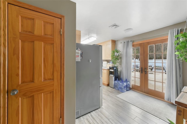 91 Meyerhoff Rd, Hurleyville, NY 12747 - interior space with light wood finished floors, french doors, freestanding refrigerator, and light countertops