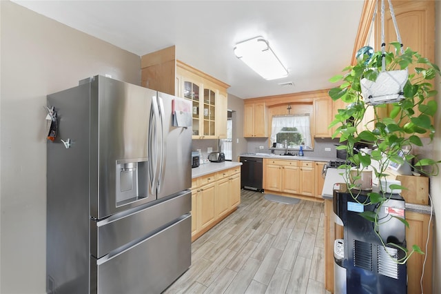 91 Meyerhoff Rd, Hurleyville, NY 12747 - kitchen with light brown cabinets, stainless steel fridge, light countertops, black dishwasher, and light wood finished floors