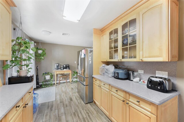 91 Meyerhoff Rd, Hurleyville, NY 12747 - kitchen featuring tasteful backsplash, light wood-style flooring, light countertops, stainless steel refrigerator with ice dispenser, and visible vents