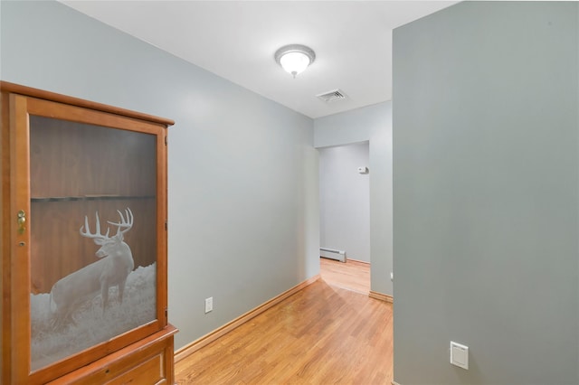 91 Meyerhoff Rd, Hurleyville, NY 12747 - hallway with visible vents, a baseboard radiator, wood finished floors, and baseboards