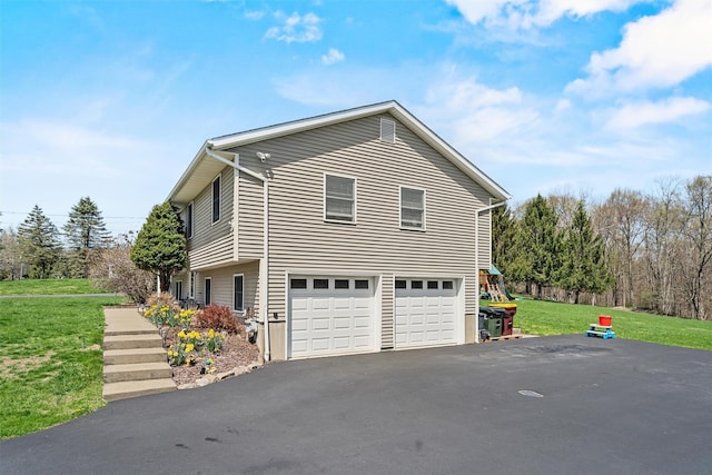 view of home's exterior with driveway, a yard, and a garage