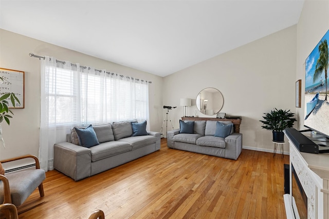 living area featuring light wood-style floors and vaulted ceiling