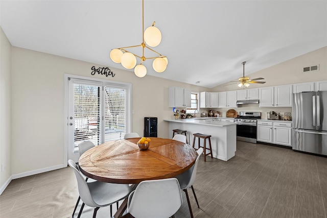 dining space with baseboards, visible vents, a ceiling fan, and vaulted ceiling
