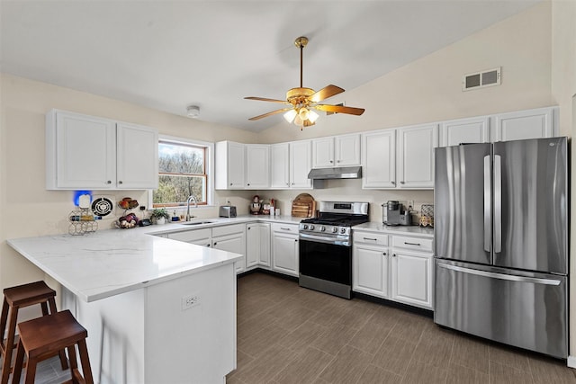 kitchen featuring stainless steel appliances, under cabinet range hood, white cabinets, visible vents, and a peninsula