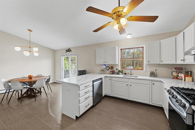 kitchen featuring white cabinetry, stainless steel appliances, a peninsula, and a sink