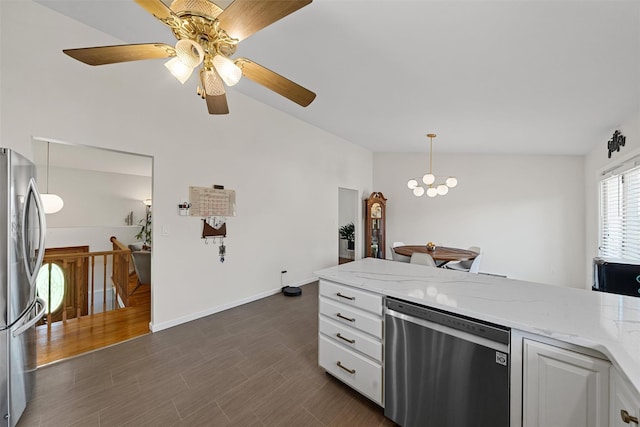kitchen with ceiling fan, stainless steel appliances, vaulted ceiling, light stone countertops, and white cabinetry
