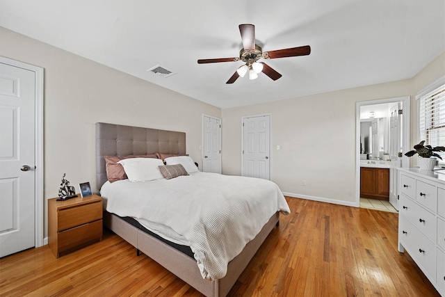 bedroom with visible vents, a ceiling fan, connected bathroom, light wood-type flooring, and baseboards