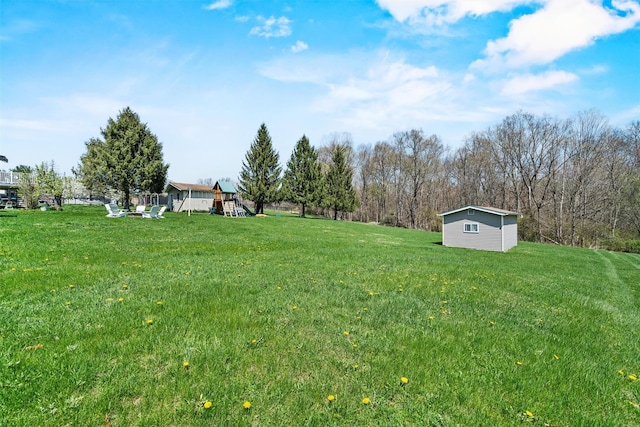 view of yard featuring an outbuilding and a playground