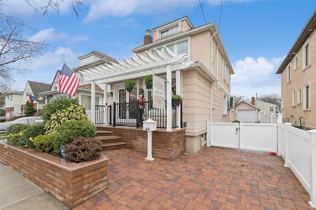 87-15 258th St, Floral Park, NY 11001 - exterior space featuring a gate, a pergola, a chimney, fence, and a residential view