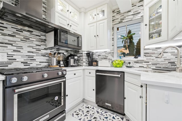 87-15 258th St, Floral Park, NY 11001 - kitchen with stainless steel appliances, backsplash, a sink, wall chimney exhaust hood, and white cabinetry