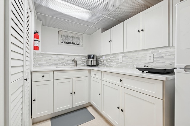 87-15 258th St, Floral Park, NY 11001 - kitchen featuring backsplash, white cabinetry, and a sink