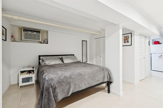 87-15 258th St, Floral Park, NY 11001 - bedroom featuring baseboards, freestanding refrigerator, a wall unit AC, and light tile patterned flooring