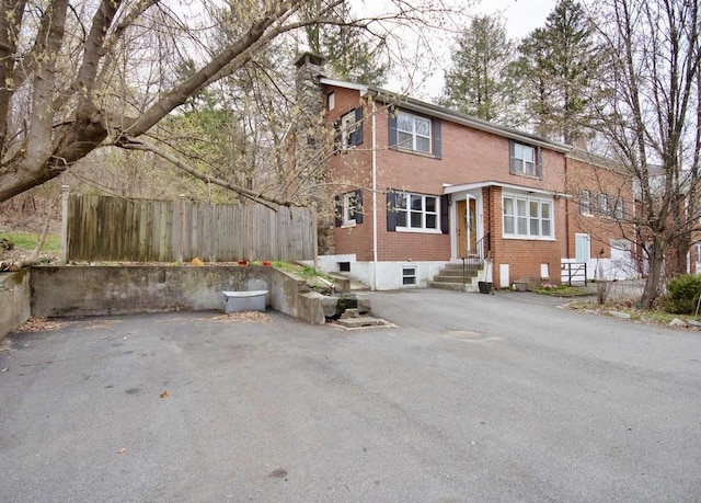 9 Old Albany Post Rd N, Cold Spring, NY 10516 - back of property with brick siding, entry steps, a chimney, and fence