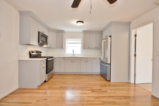 9 Old Albany Post Rd N, Cold Spring, NY 10516 - kitchen featuring a ceiling fan, a sink, light wood-style flooring, tasteful backsplash, and appliances with stainless steel finishes