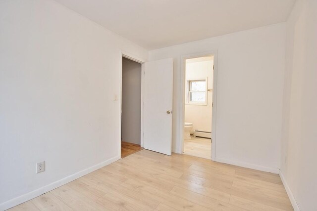 9 Old Albany Post Rd N, Cold Spring, NY 10516 - empty room with a baseboard radiator, light wood-style flooring, and baseboards