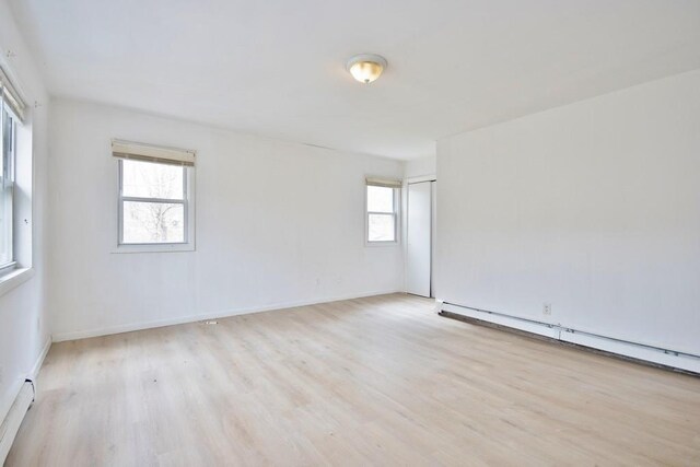 9 Old Albany Post Rd N, Cold Spring, NY 10516 - spare room featuring baseboard heating, baseboards, wood finished floors, and plenty of natural light