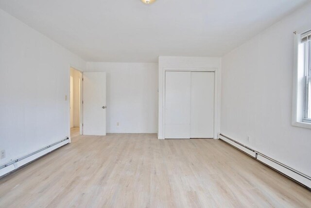 9 Old Albany Post Rd N, Cold Spring, NY 10516 - empty room featuring a baseboard radiator, light wood-style floors, and baseboard heating