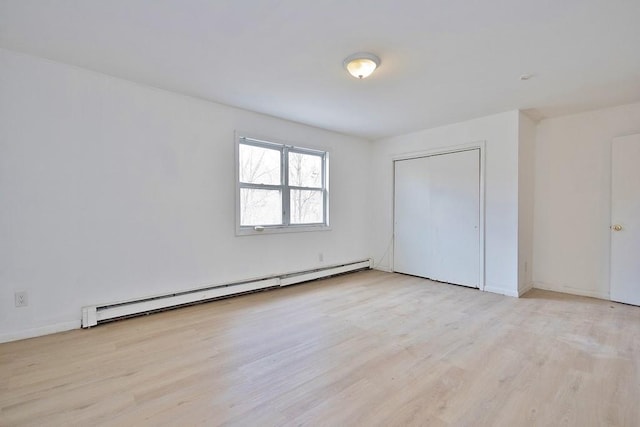 9 Old Albany Post Rd N, Cold Spring, NY 10516 - unfurnished bedroom with a baseboard heating unit, baseboards, and wood finished floors