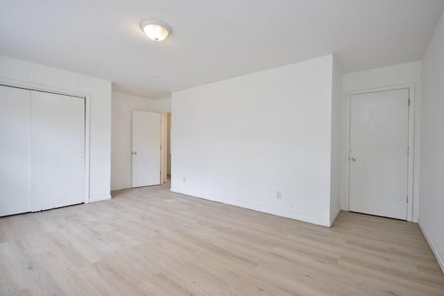 9 Old Albany Post Rd N, Cold Spring, NY 10516 - unfurnished bedroom featuring light wood-style flooring, baseboards, and a closet