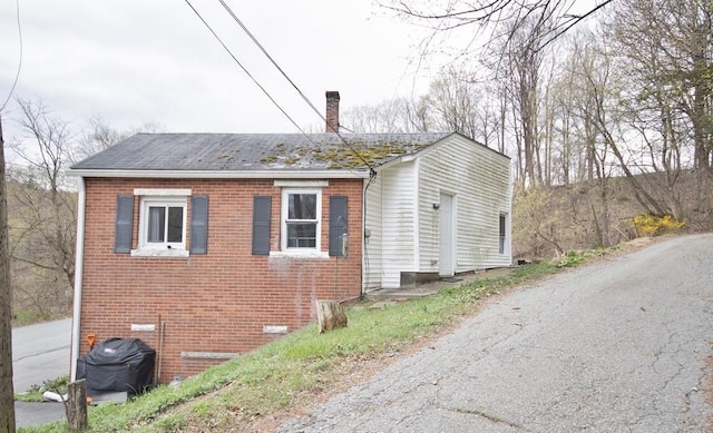 9 Old Albany Post Rd N, Cold Spring, NY 10516 - view of home's exterior with a chimney, brick siding, and a shingled roof
