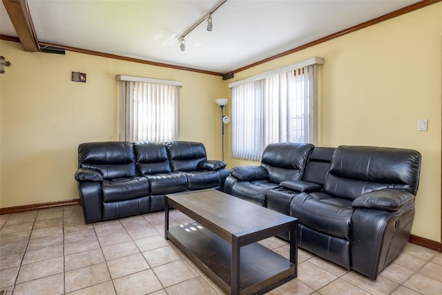 living area with track lighting, a wealth of natural light, light tile patterned flooring, and baseboards