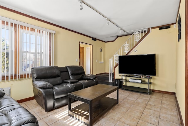 living area featuring baseboards, track lighting, light tile patterned floors, crown molding, and stairs