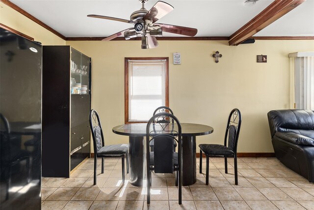 dining space featuring crown molding, ceiling fan, baseboards, and light tile patterned floors