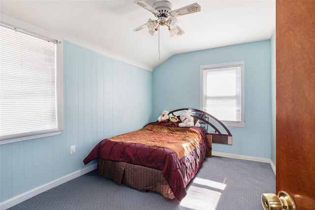 carpeted bedroom with ceiling fan, baseboards, and lofted ceiling