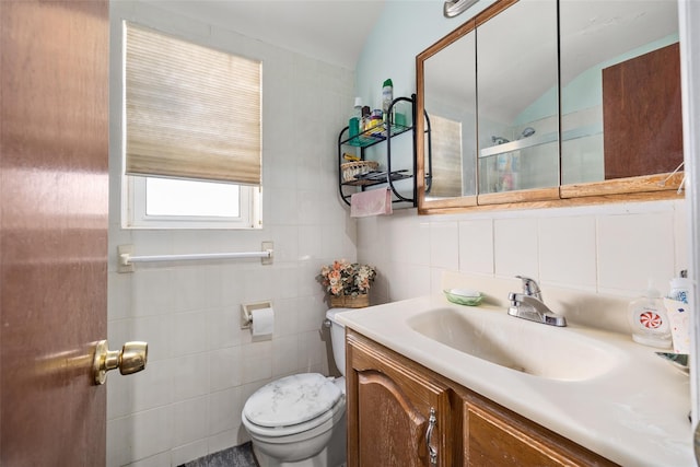 full bath featuring vanity, tile walls, walk in shower, and toilet