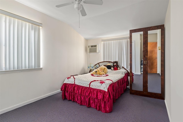 bedroom with carpet flooring, an AC wall unit, baseboards, and ceiling fan