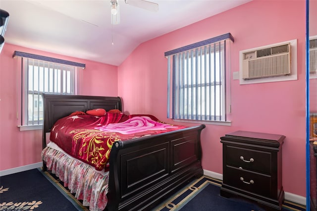 bedroom with a wall mounted air conditioner, baseboards, a ceiling fan, and lofted ceiling