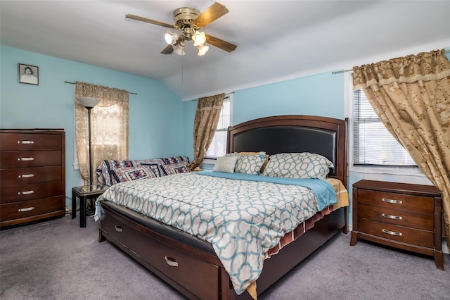 bedroom with lofted ceiling, ceiling fan, and carpet floors