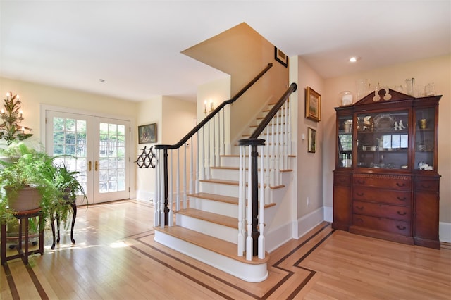 staircase with baseboards, french doors, recessed lighting, and wood finished floors
