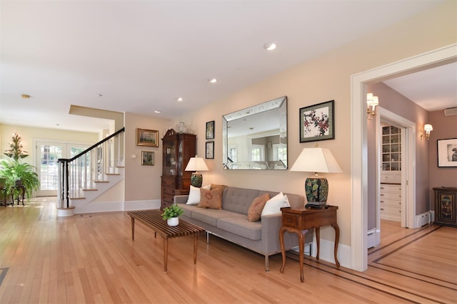 living area featuring stairway, baseboards, recessed lighting, and light wood finished floors