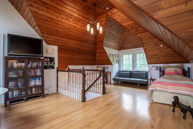bedroom with wood ceiling, wood finished floors, wooden walls, and high vaulted ceiling
