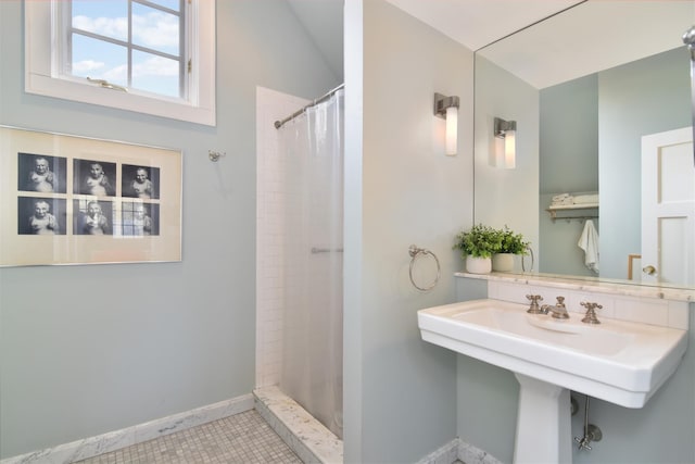 bathroom with baseboards, tile patterned floors, and a shower with curtain