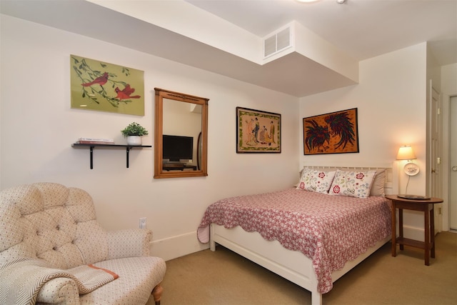 carpeted bedroom with visible vents and baseboards