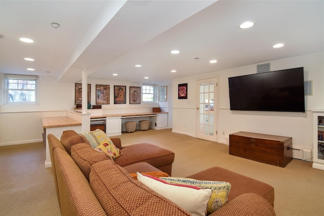 living area with baseboards, recessed lighting, and light colored carpet