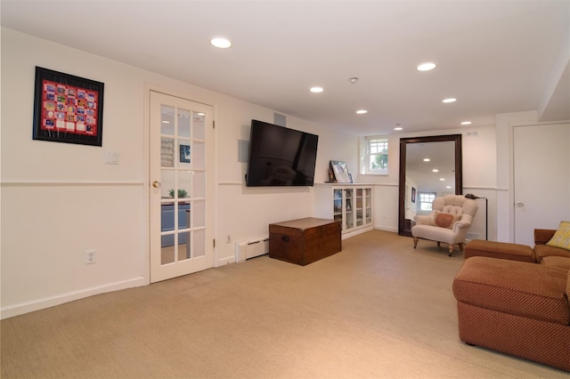 living area with recessed lighting, baseboards, a baseboard heating unit, and light carpet