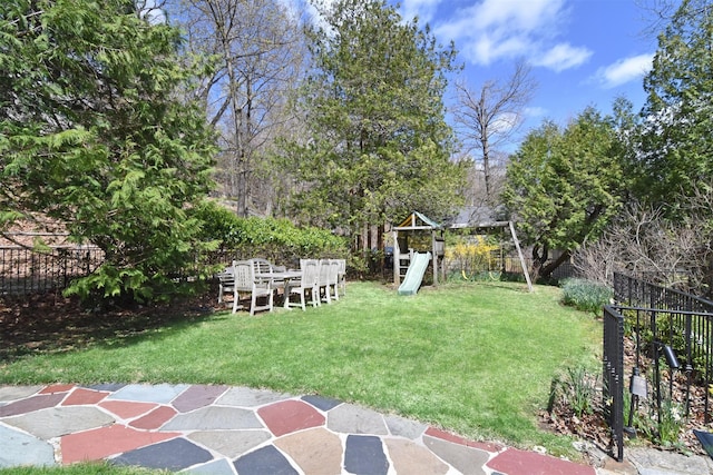 view of yard featuring a playground and fence