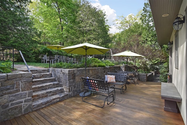 wooden terrace with outdoor dining area