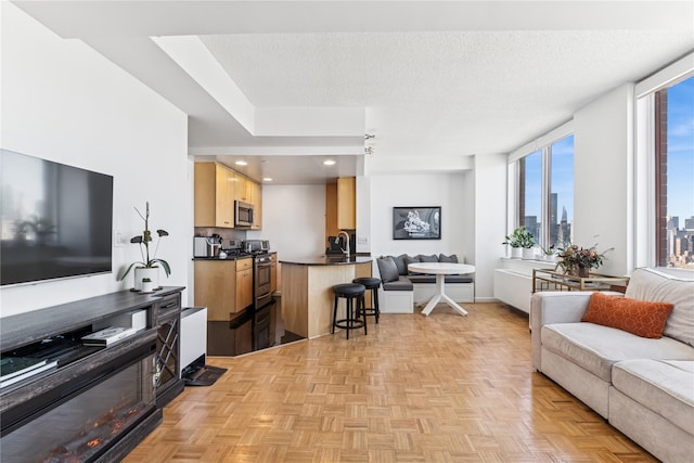 4-74 48th Ave Unit Ph4D, Long Island City, NY 11109 - living room with recessed lighting, a view of city, and a textured ceiling