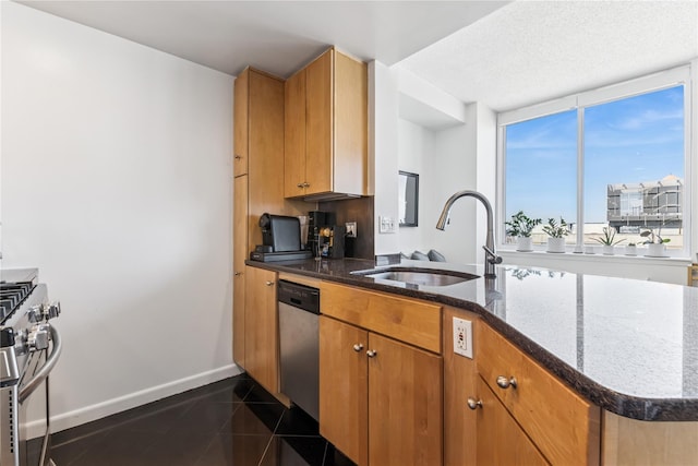 4-74 48th Ave Unit Ph4D, Long Island City, NY 11109 - kitchen with a sink, stainless steel appliances, dark stone countertops, baseboards, and a peninsula