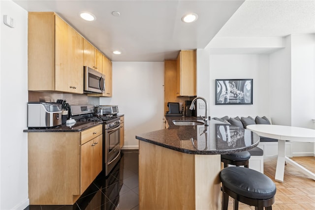 4-74 48th Ave Unit Ph4D, Long Island City, NY 11109 - kitchen featuring appliances with stainless steel finishes, a sink, baseboards, a kitchen bar, and recessed lighting