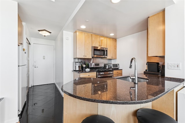 4-74 48th Ave Unit Ph4D, Long Island City, NY 11109 - kitchen with stainless steel appliances, a sink, light brown cabinets, a peninsula, and dark stone counters