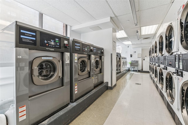 4-74 48th Ave Unit Ph4D, Long Island City, NY 11109 - community laundry room featuring estacked washer and dryer, washing machine and clothes dryer, and tile patterned floors