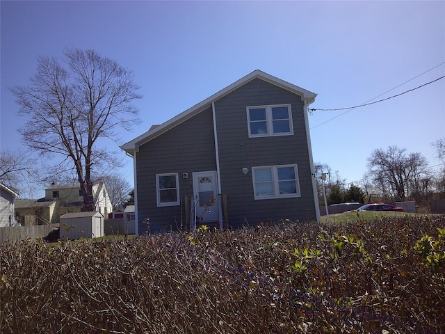 view of front of house featuring an outbuilding and a storage unit
