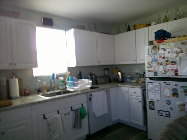 kitchen featuring visible vents, white cabinets, and freestanding refrigerator