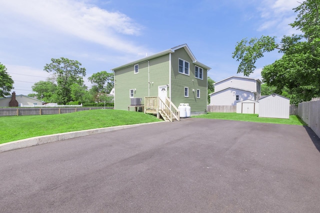 2 Lafayette Dr, Shirley, NY 11967 - rear view of house with a shed, a fenced backyard, and driveway
